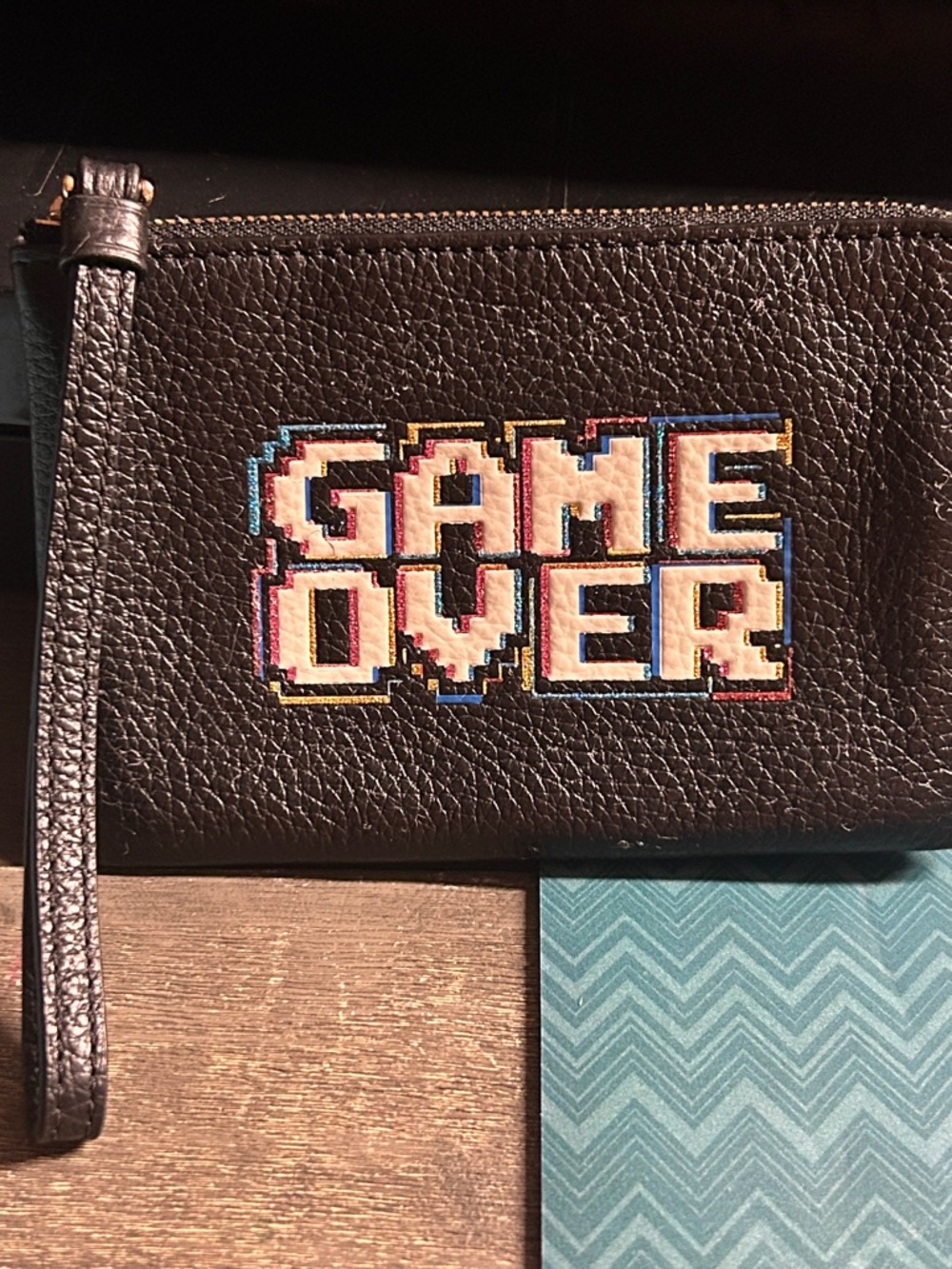 Coach Corner Zip Wristlet featuring a Pac-Man "Game Over" design, model F73399. - Picture 2 of 2